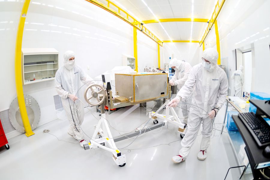 Staff working on hardware in a cleanroom.